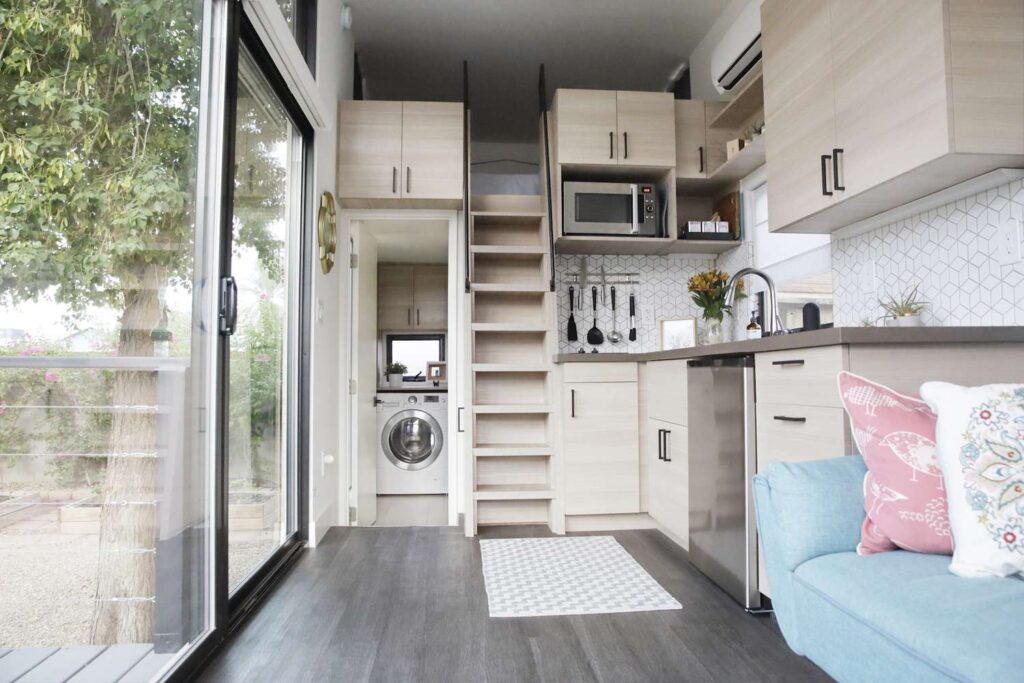 Modern tiny home kitchen and storage setup showcasing efficient use of space – ideal for those searching for tiny home resources.