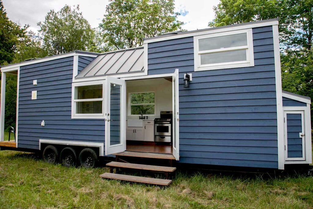 Modern blue tiny home on wheels, ideal for exploring tiny home financing options