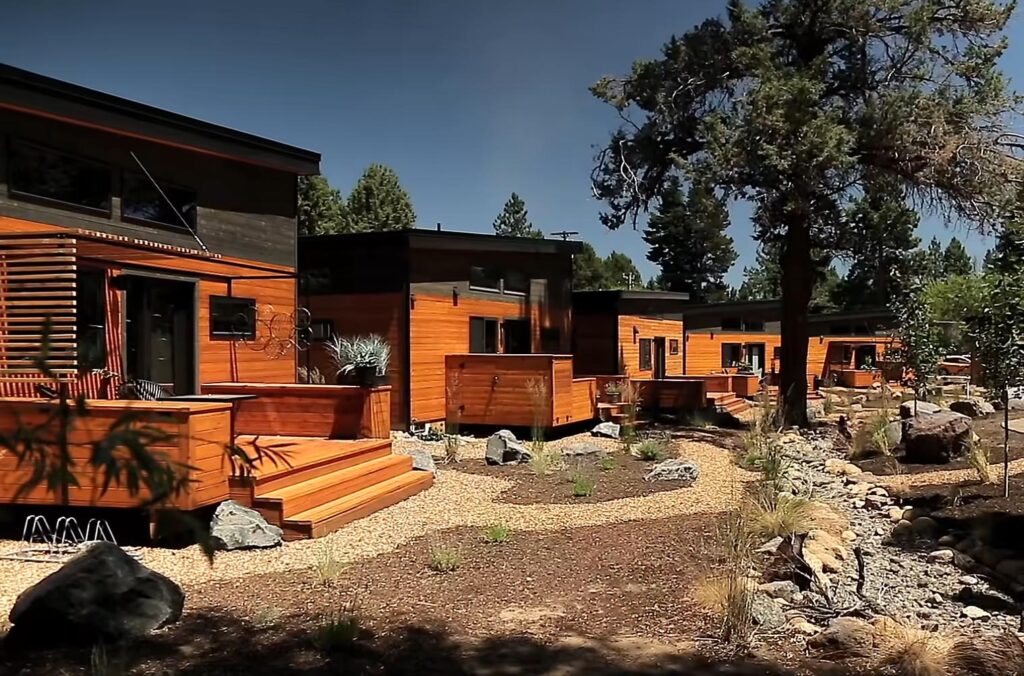 People participating in tiny home community events with shared green space