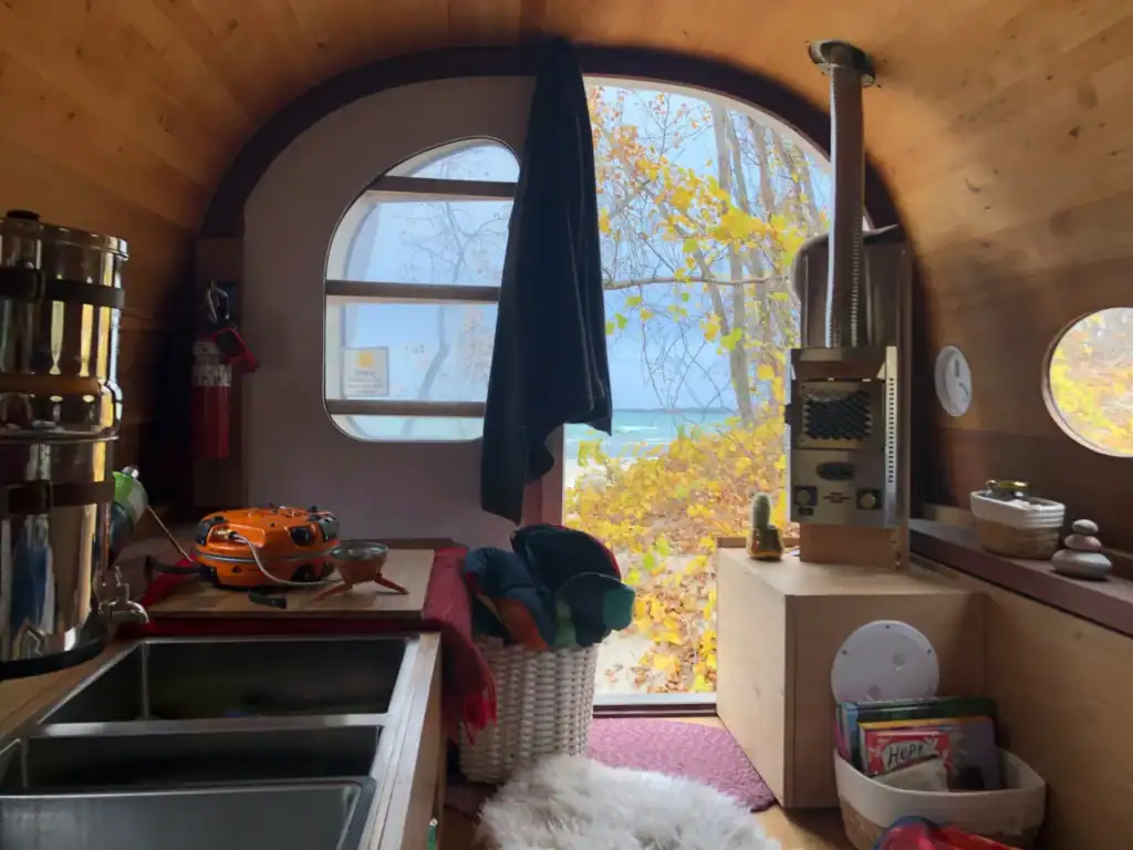Off-grid Tiny Home with Panoramic View Cozy tiny home interior with lake view by one of the best tiny home builders in the USA