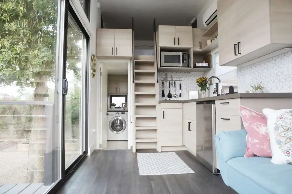 Compact Modern Kitchen and Loft in a Tiny Home tiny home resources with modern interior and loft stairs