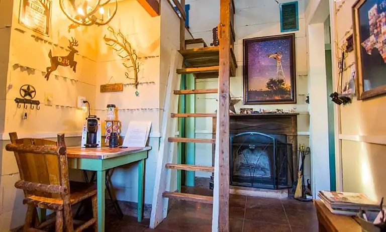 Cozy Rustic Tiny Home with Ladder and Fireplace tiny home resources with rustic interior and fireplace