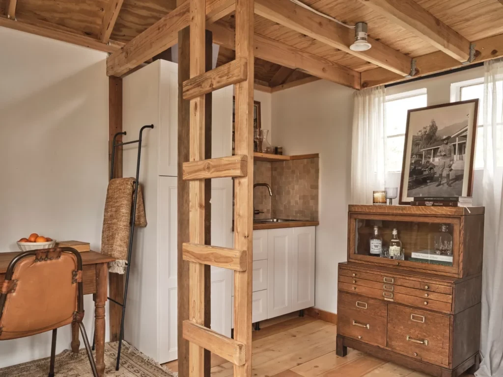 Elevated bedroom in the 11 square meter tiny house Loft bed setup in the 11 square meter tiny house with exposed wood beams