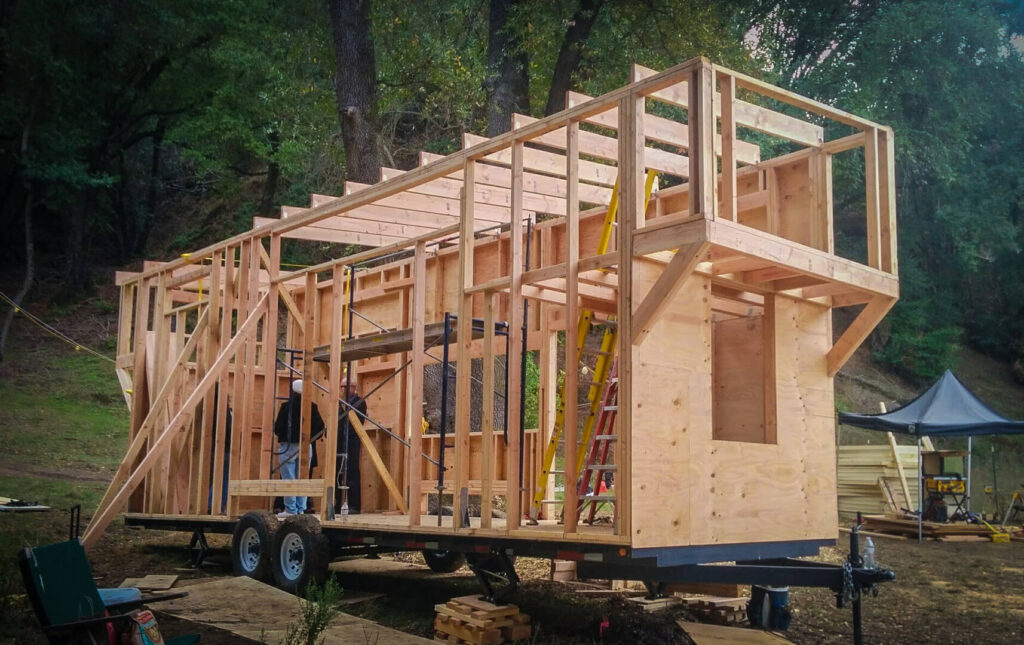 Tiny Home Builders Constructing Mobile Tiny House Frame Framing stage of a tiny house on wheels by professional tiny home builders