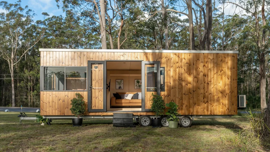 Wooden eco friendly tiny house with open doors and indoor plants