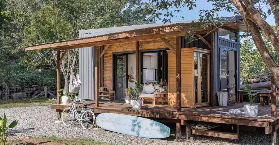 Cozy Tiny Home with Outdoor Living in California Tiny home built by one of the top tiny home builders in California with a porch and rustic decor