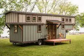 Compact Mobile Tiny House with Scenic Background Compact two-tone mobile tiny home with lake view built by experienced tiny house builders
