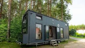 Modern tiny home surrounded by pine trees, built by top tiny house companies.