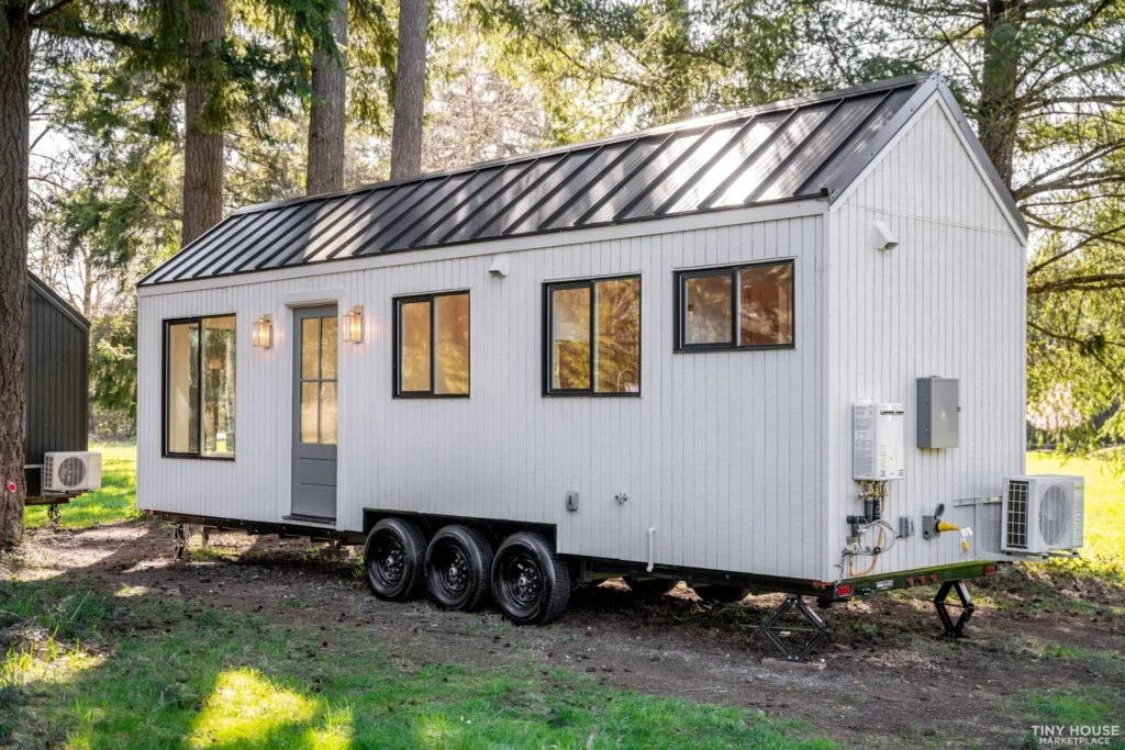 Blue and gray tiny house on wheels with staircase, built by a top tiny house company.