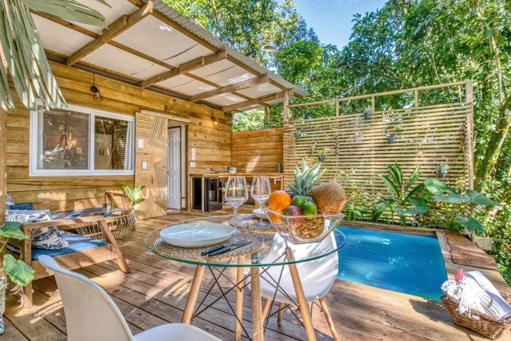 Eco-Friendly Tiny Home with Natural Shade Tiny home surrounded by trees with shade and passive cooling design