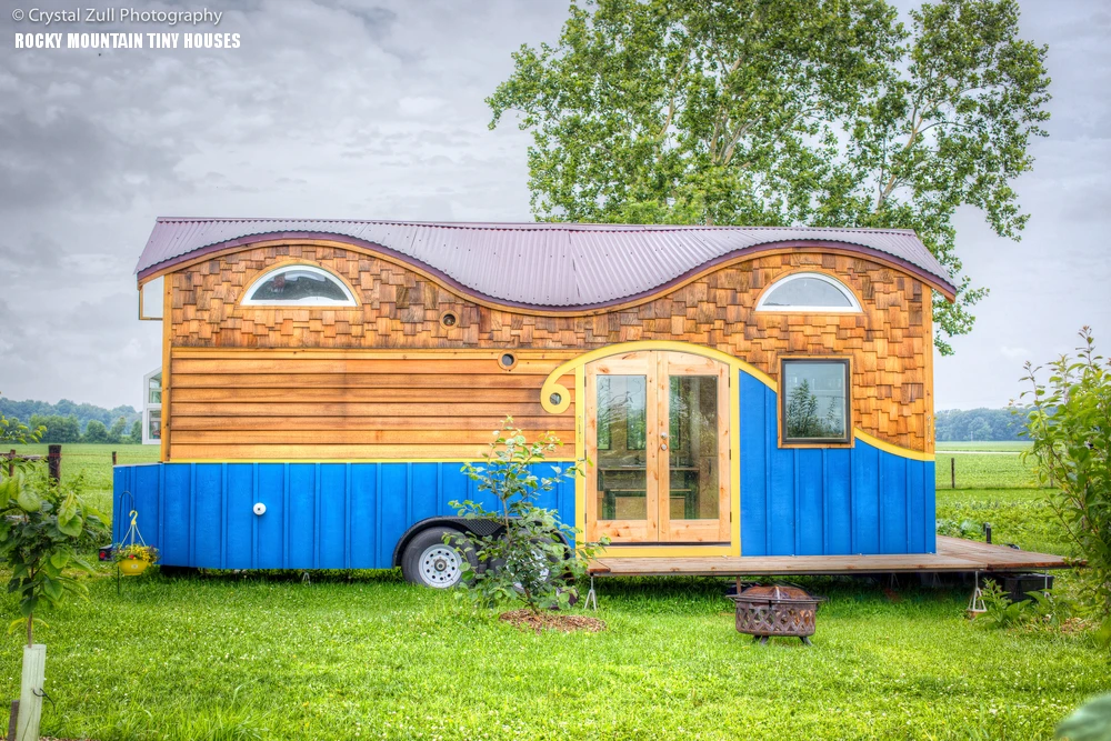 Artistic Tiny Home by Rocky Mountain Tiny Houses Colorful tiny home with artistic wood and blue siding, built by Rocky Mountain Tiny Houses.