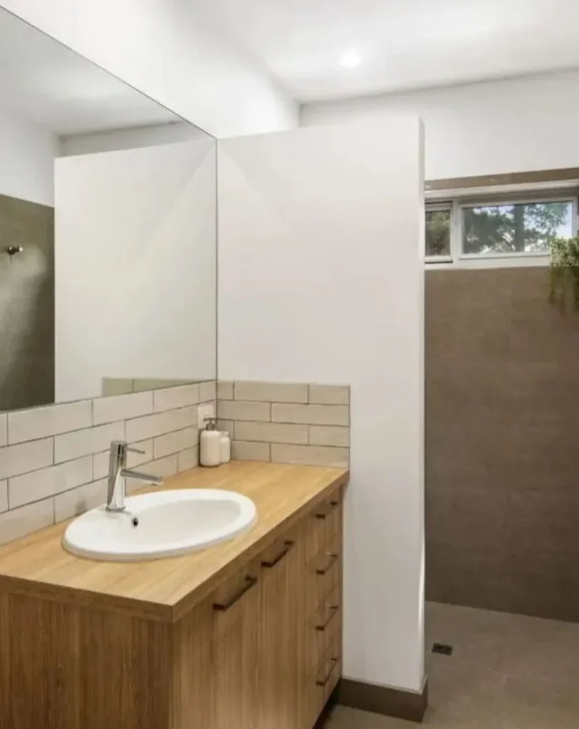 Bathroom in a Custom Built Tiny Home Modern bathroom design inside a custom built tiny home with wood vanity