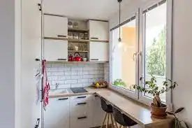 Small bright kitchen showing smart shelves and counter, perfect for tiny home kitchen storage ideas.