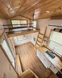 Minimalist kitchen and loft by one of the best tiny home manufacturers in America 2025.