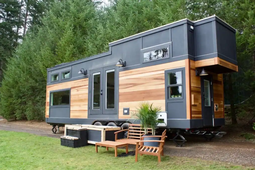 Modern tiny home builders using wood and steel to craft sustainable small homes.